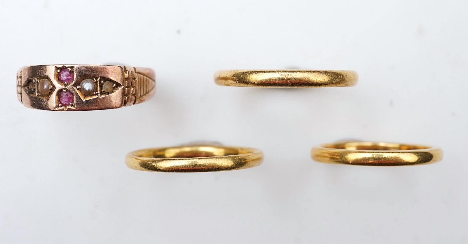 A collection of four gold rings
